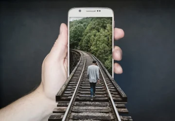 Close-up of diverse hands some holding a smartphone displaying the Ehsan platform logo or