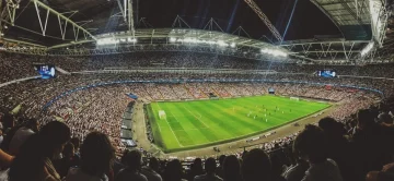Passionate football fans watching a high-stakes football match on multiple screens with th