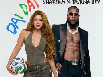 Shakira and Burna Boy singing at a football stadium